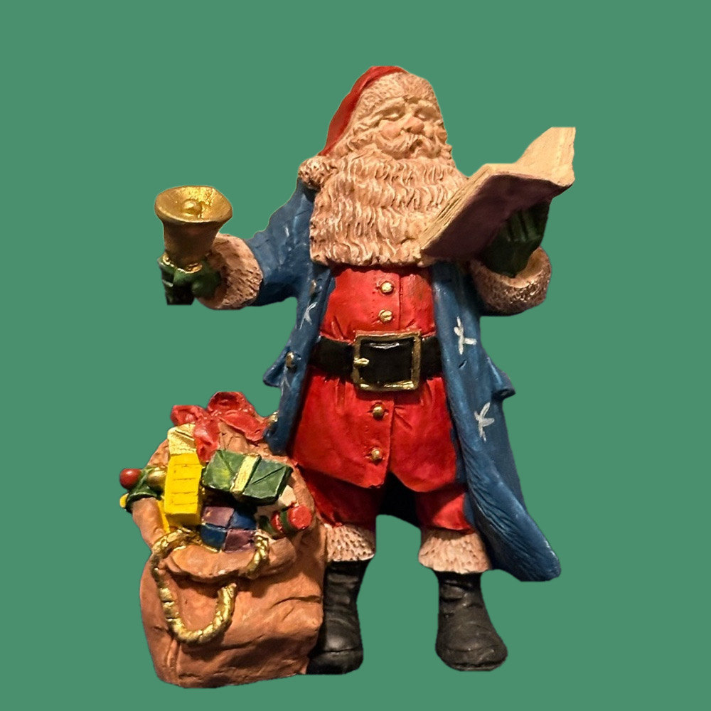 Gorgeous blue robed Santa rings a bell and reads to the crowds!